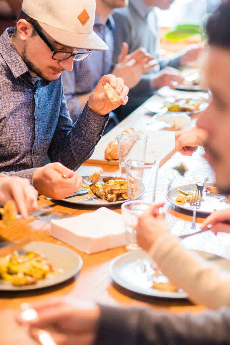 A group of adults enjoying a casual meal together, sharing friendship and good food.